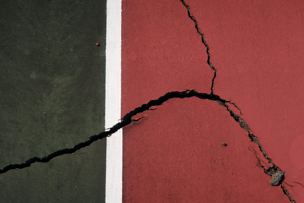 tennis court with cracks in pavement