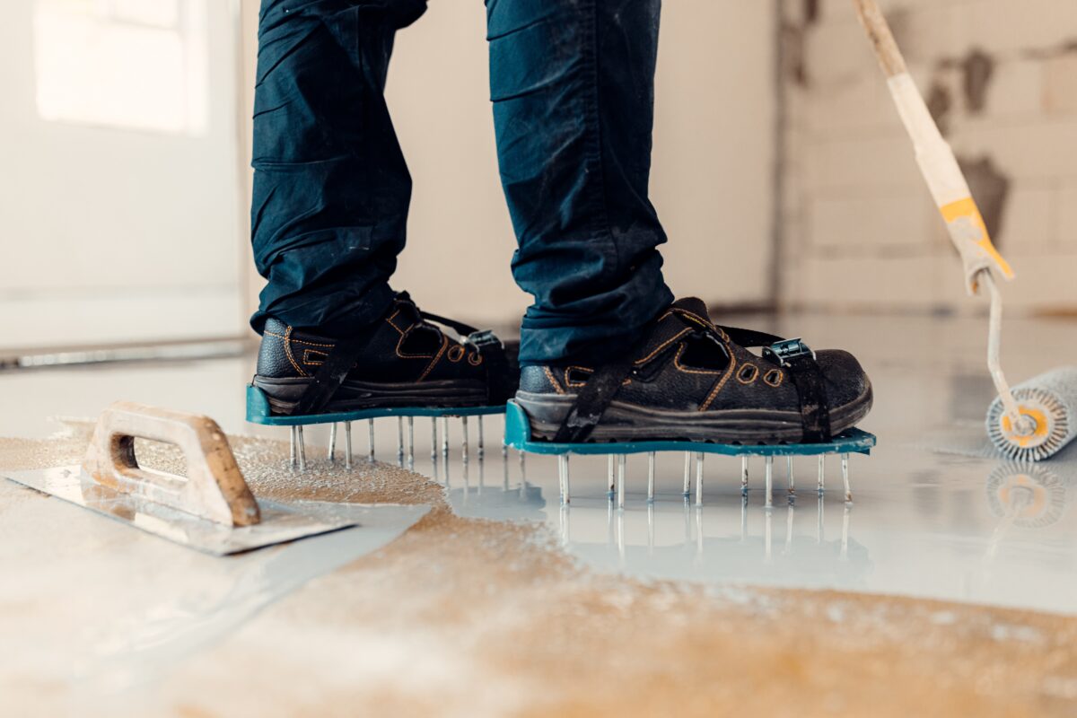 epoxy flooring installer shoes wearing specialized stilts